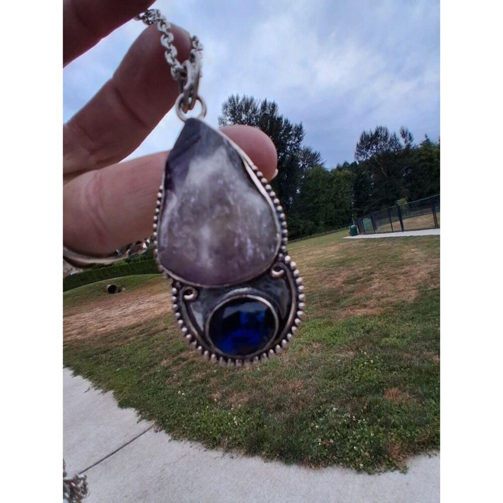 Chunky raw amethyst with deep blue crystal pendant
